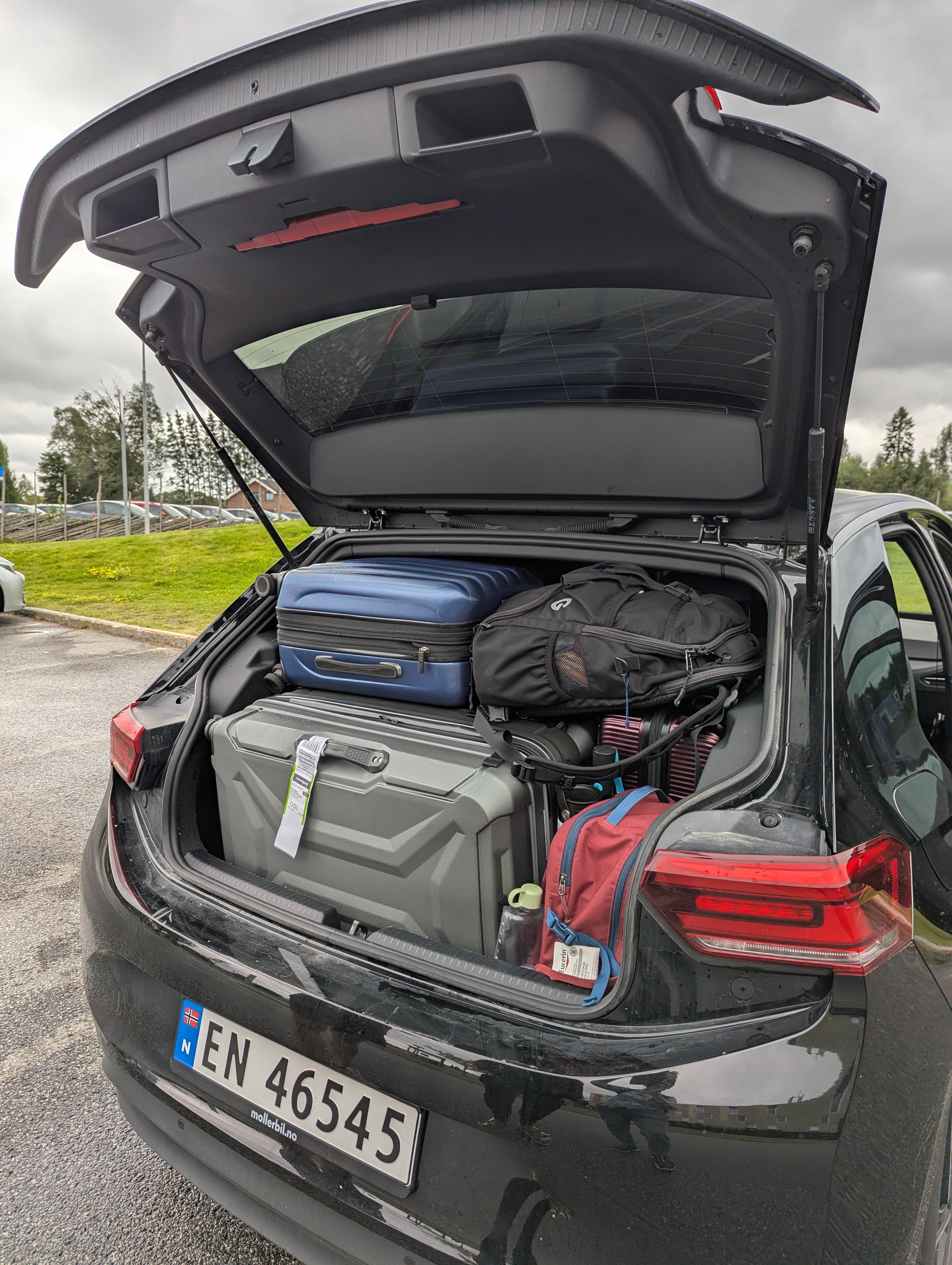 picture of an open trunk on a car packed with lugguage